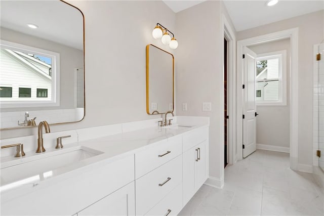 bathroom with plenty of natural light and vanity