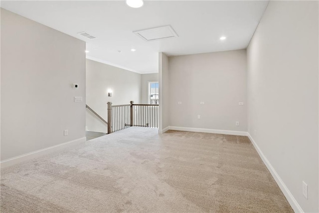 carpeted spare room featuring ornamental molding