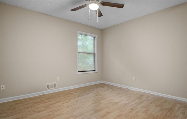 empty room featuring light hardwood / wood-style flooring and ceiling fan