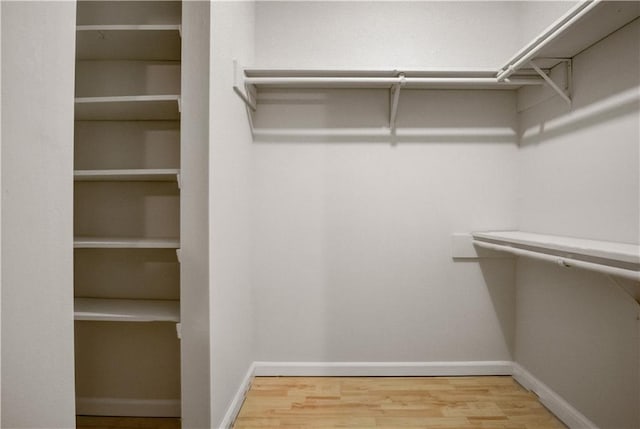 walk in closet featuring hardwood / wood-style flooring