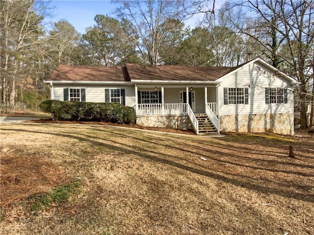 ranch-style house featuring a front yard, covered porch, and crawl space