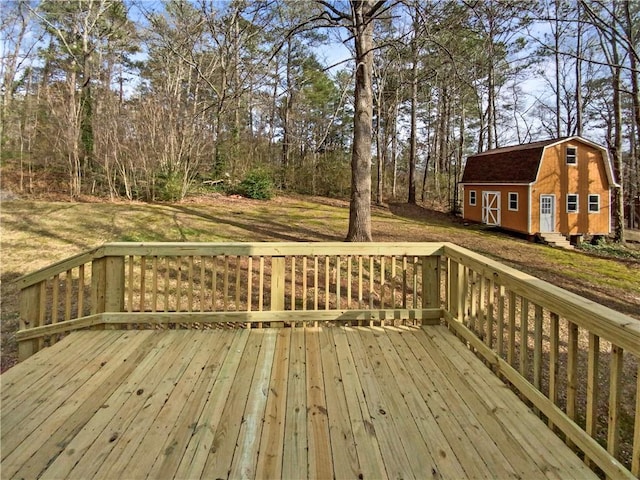 wooden deck with an outbuilding and a lawn