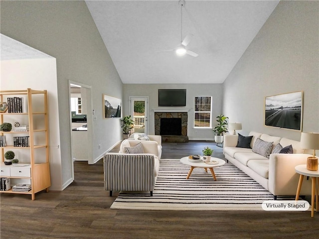 living room with a stone fireplace, high vaulted ceiling, wood finished floors, and ceiling fan