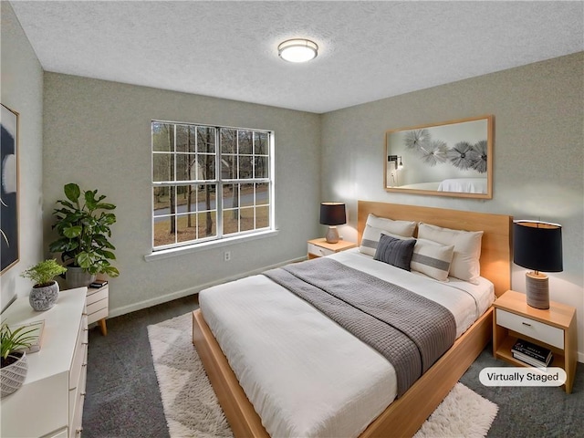 carpeted bedroom with a textured ceiling and baseboards