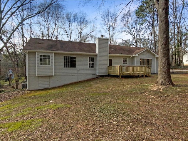 rear view of house with a deck, crawl space, and a chimney