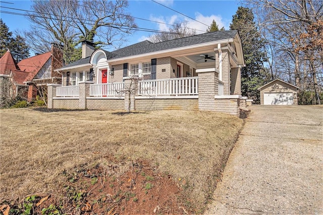 view of front of home featuring a porch, a chimney, an outdoor structure, and a detached garage