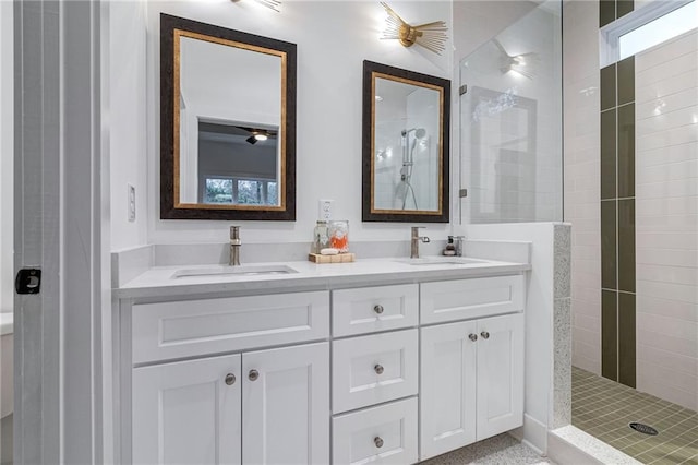 bathroom featuring vanity and tiled shower