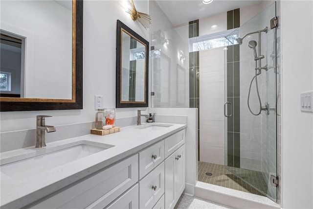 bathroom with a shower with door and vanity