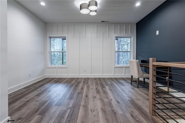 office space with hardwood / wood-style flooring and a healthy amount of sunlight