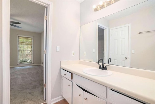 bathroom with vanity and baseboards