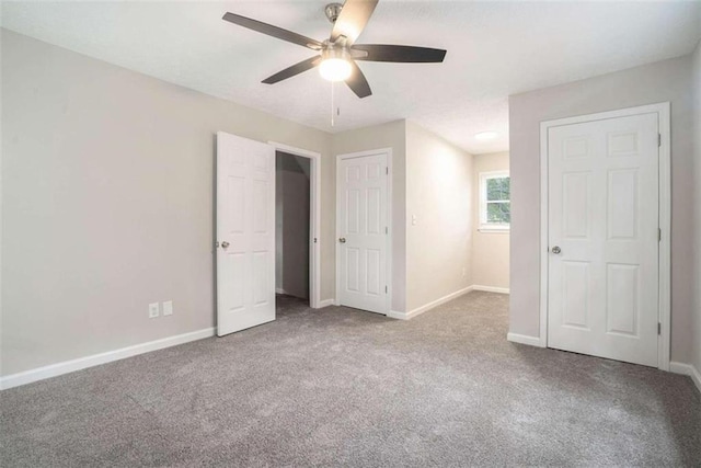 unfurnished bedroom featuring ceiling fan, carpet flooring, and baseboards