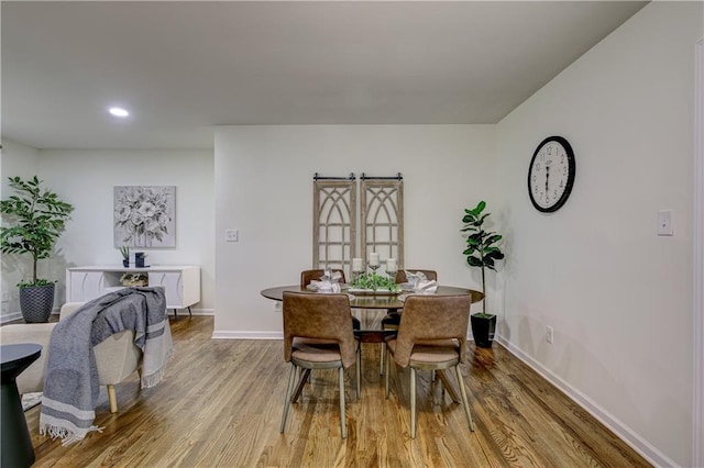 dining space with light hardwood / wood-style floors