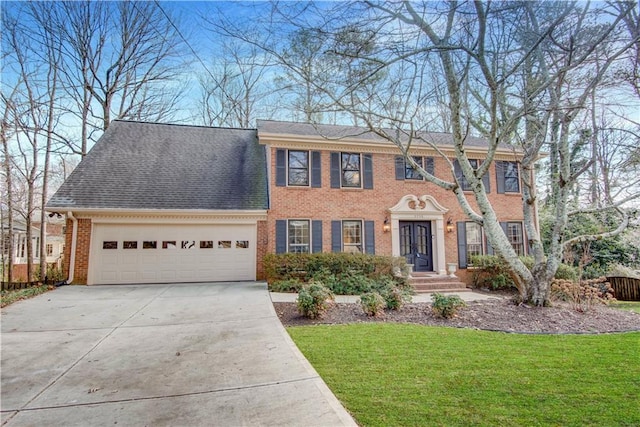 colonial home with a garage and a front yard