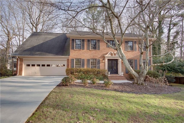 view of front of property with a garage and a front lawn