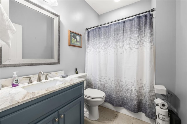 bathroom featuring tile patterned flooring, vanity, toilet, and walk in shower