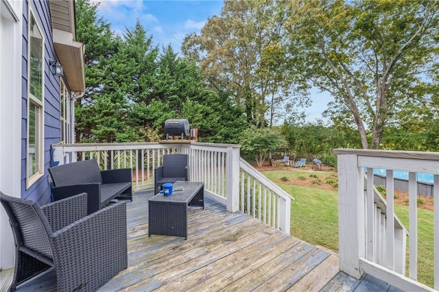 wooden terrace featuring a grill, an outdoor hangout area, and a lawn