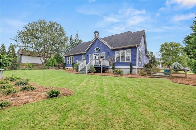 back of house with a wooden deck and a yard