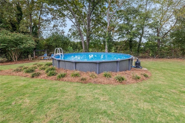 view of pool with a yard