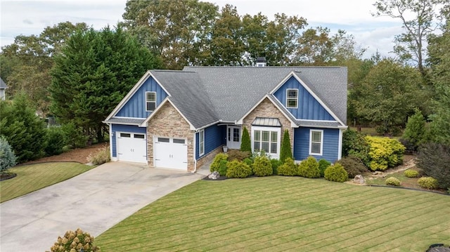 craftsman inspired home featuring a garage and a front lawn