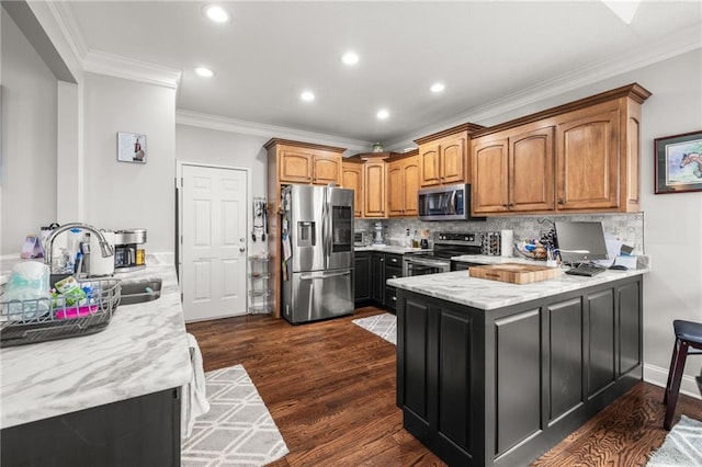 kitchen featuring dark wood-type flooring, sink, crown molding, appliances with stainless steel finishes, and light stone countertops