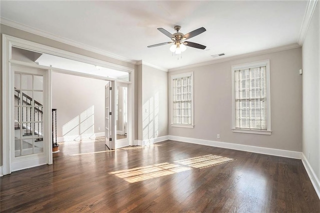 spare room featuring crown molding, dark wood-type flooring, and ceiling fan