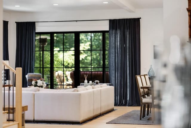 living room with beam ceiling and wood-type flooring