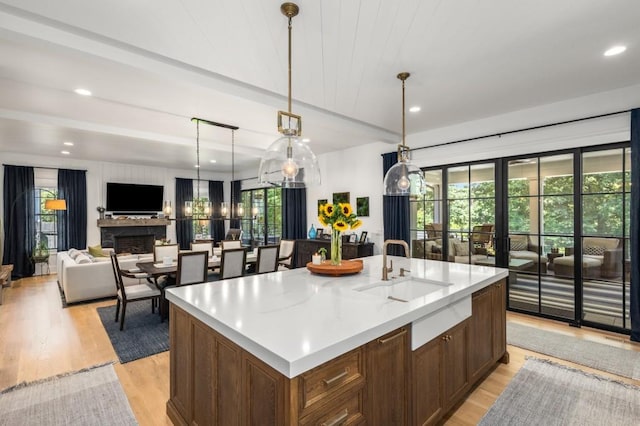 kitchen with a center island with sink, plenty of natural light, and hanging light fixtures