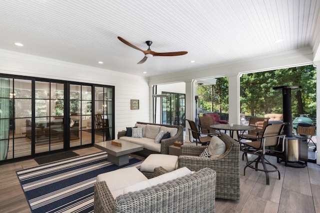 sunroom with ceiling fan and wood ceiling