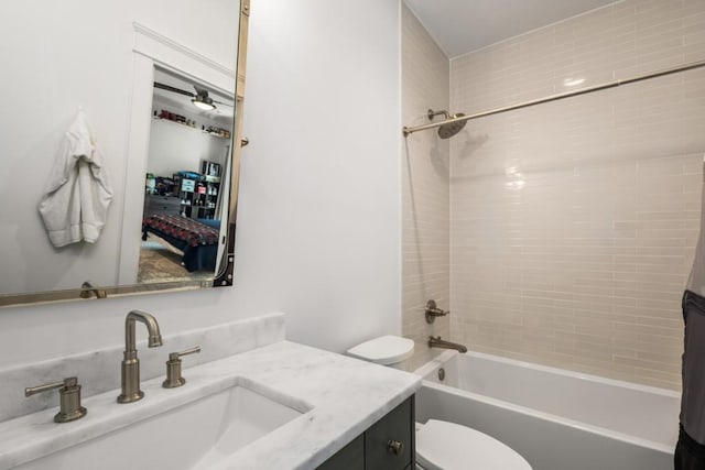 full bathroom featuring vanity, toilet, and tiled shower / bath combo