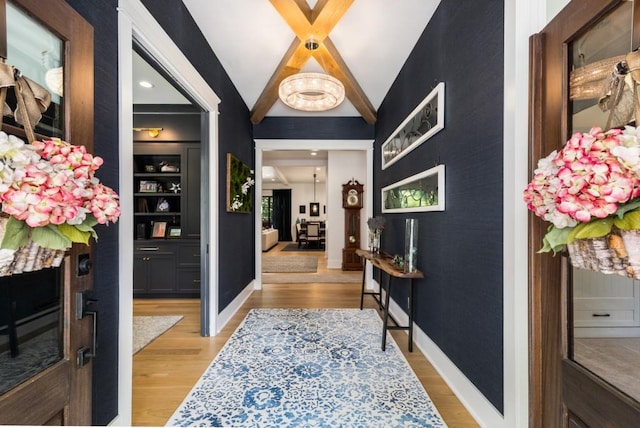 hall featuring lofted ceiling and light hardwood / wood-style flooring