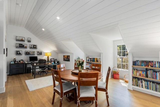 dining area featuring vaulted ceiling, light hardwood / wood-style flooring, and wooden ceiling