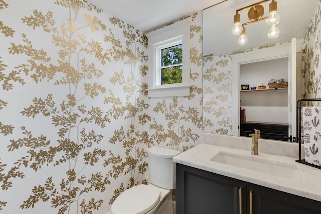 bathroom featuring vanity and toilet