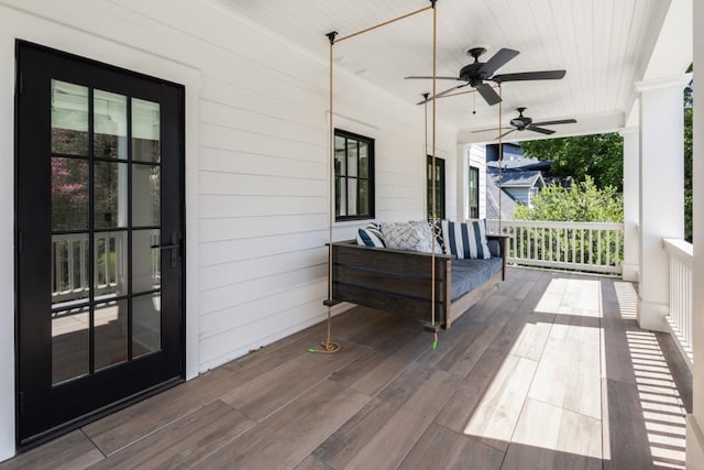 wooden deck featuring a porch and ceiling fan