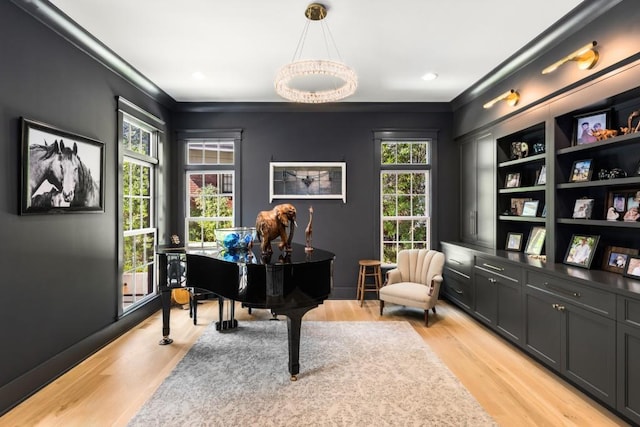 misc room with light wood-type flooring and crown molding