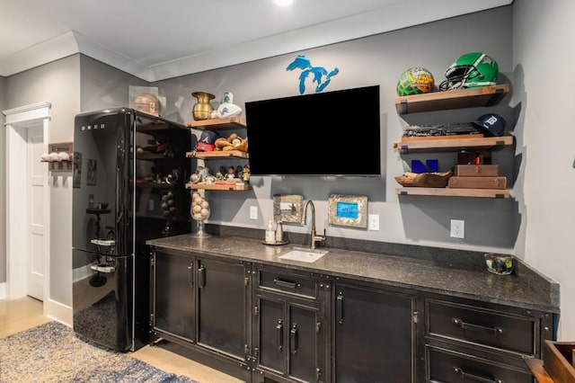 bar with black fridge, sink, and ornamental molding