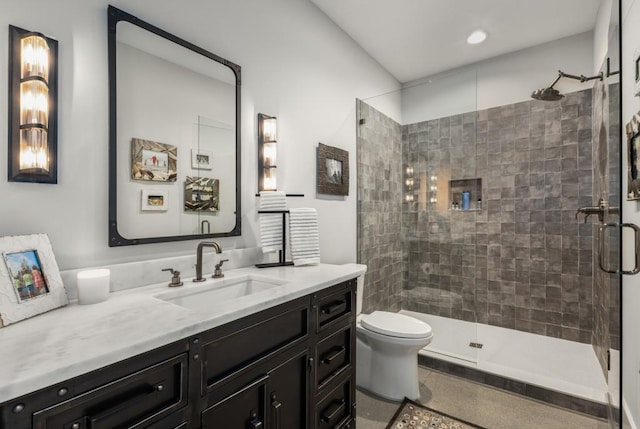 bathroom with vanity, toilet, and a shower with shower door