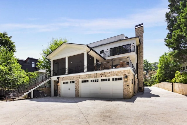 view of front of house featuring a sunroom and a garage