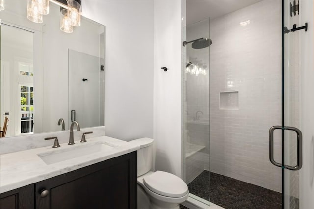 bathroom with vanity, an enclosed shower, and toilet