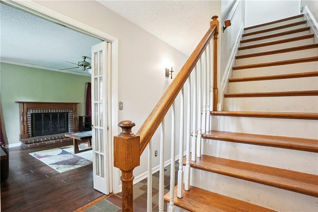 285 Aspen Way, Fayetteville, GA 30214 - staircase with ceiling fan, a textured ceiling, a fireplace, and wood finished floors