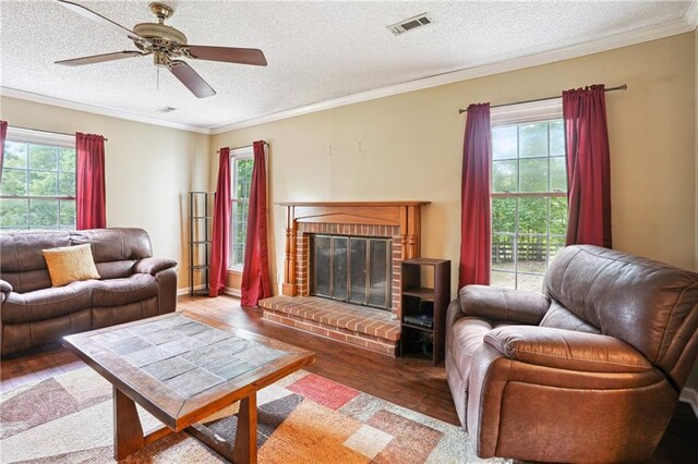 285 Aspen Way, Fayetteville, GA 30214 - living area with wood finished floors, ceiling fan, a textured ceiling, ornamental molding, and a fireplace