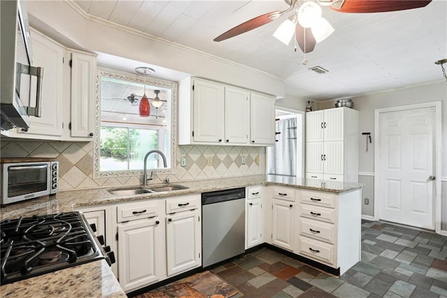 285 Aspen Way, Fayetteville, GA 30214 - kitchen with stainless steel appliances, a sink, white cabinetry, a peninsula, and ornamental molding