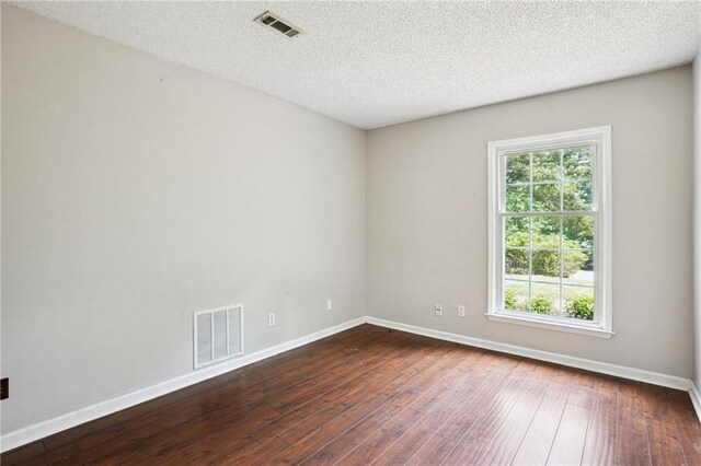 285 Aspen Way, Fayetteville, GA 30214 - unfurnished room featuring dark wood finished floors, baseboards, and a textured ceiling