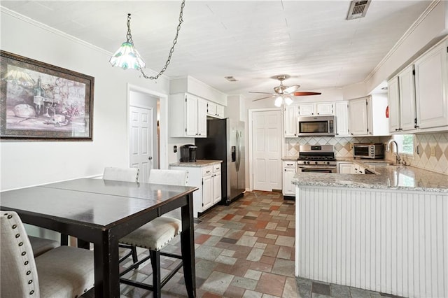285 Aspen Way, Fayetteville, GA 30214 - kitchen featuring stainless steel appliances, backsplash, a peninsula, a sink, and light stone counters