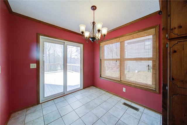 unfurnished dining area featuring visible vents, a textured ceiling, an inviting chandelier, crown molding, and light tile patterned floors