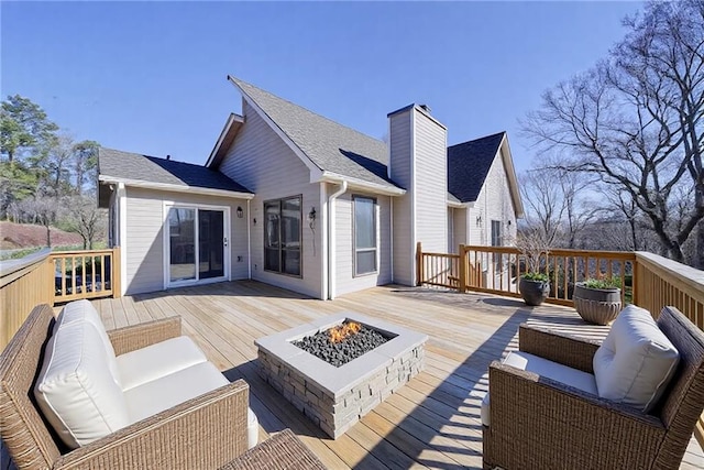 wooden deck with an outdoor living space with a fire pit