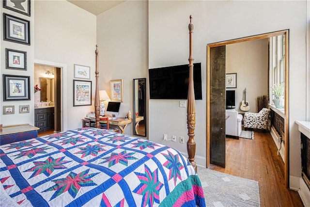 978 N Ave NE Unit 207, Atlanta, GA 30306 - bedroom featuring a towering ceiling, ensuite bath, and wood finished floors