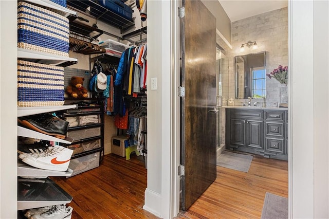 978 N Ave NE Unit 207, Atlanta, GA 30306 - full bath featuring wood finished floors, vanity, visible vents, a stall shower, and a walk in closet