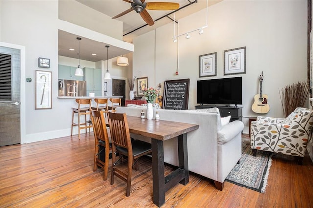 978 N Ave NE Unit 207, Atlanta, GA 30306 - living room featuring a high ceiling, baseboards, a ceiling fan, and wood finished floors