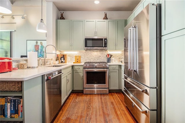 978 N Ave NE Unit 207, Atlanta, GA 30306 - kitchen with stainless steel appliances, a sink, a peninsula, decorative backsplash, and light countertops