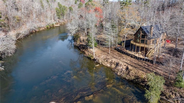 bird's eye view with a wooded view